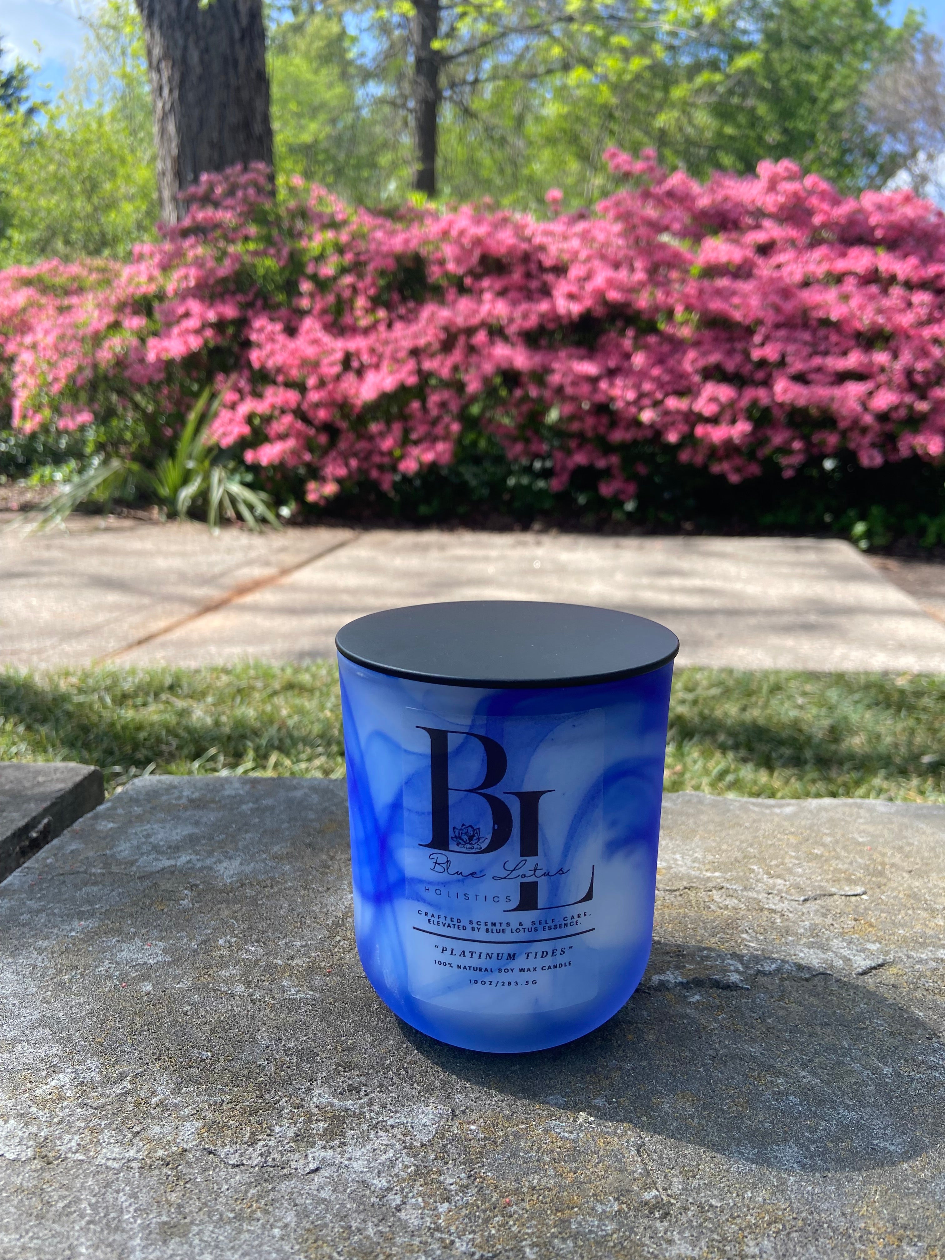 Platinum Tides natural soy candle displayed in an outdoor lifestyle setting
